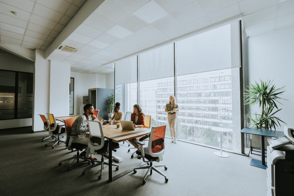 Office meeting room with screens drawn across a full-height glazed wall